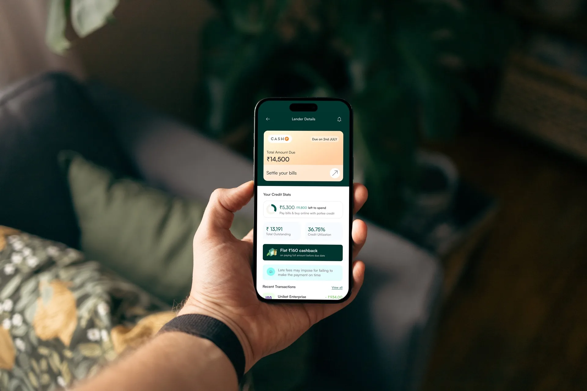Hand holding phone showing lender details and credit stats